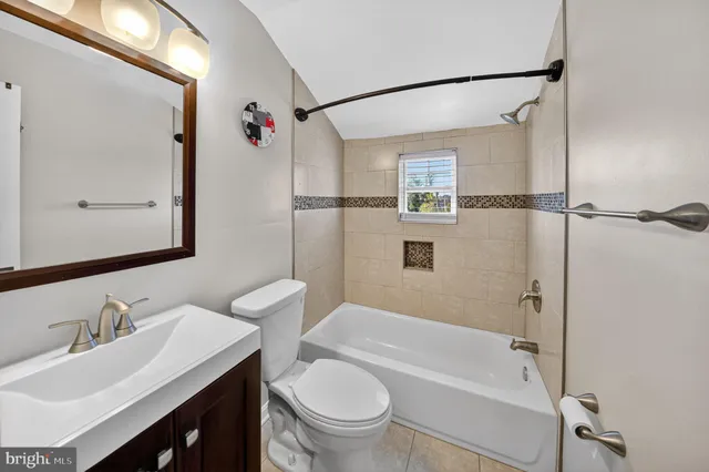 a bathroom with a sink vanity mirror and toilet