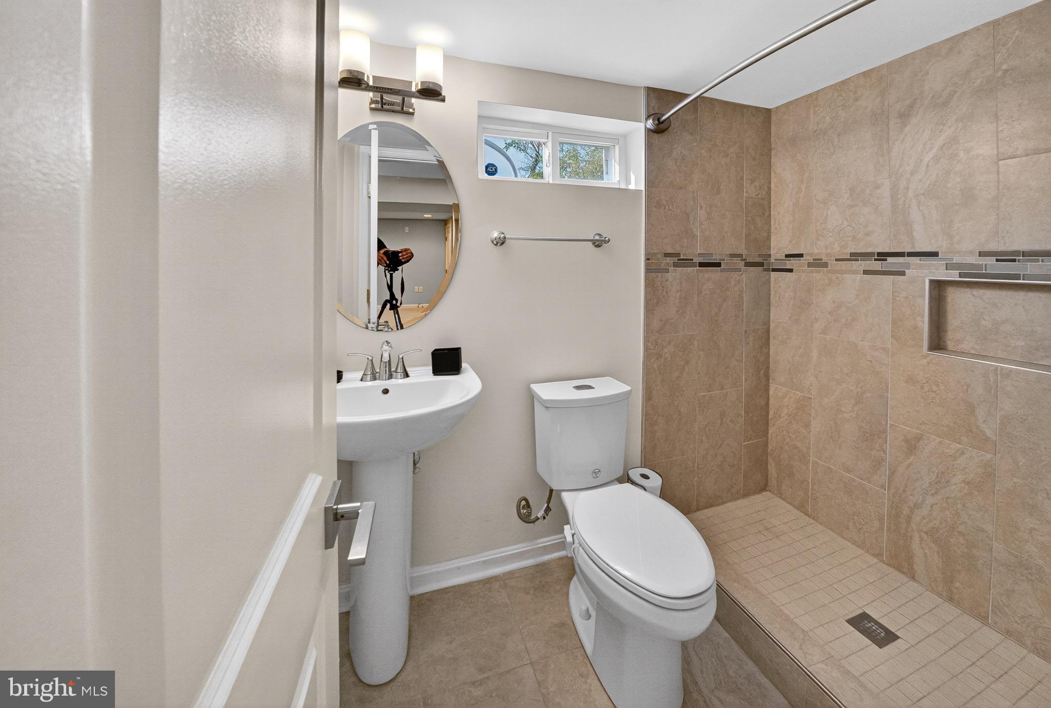 5211 Jay Street Northeast Washington, DC 20019 - Photo 15 of 17 a white toilet sitting next to a bathroom sink