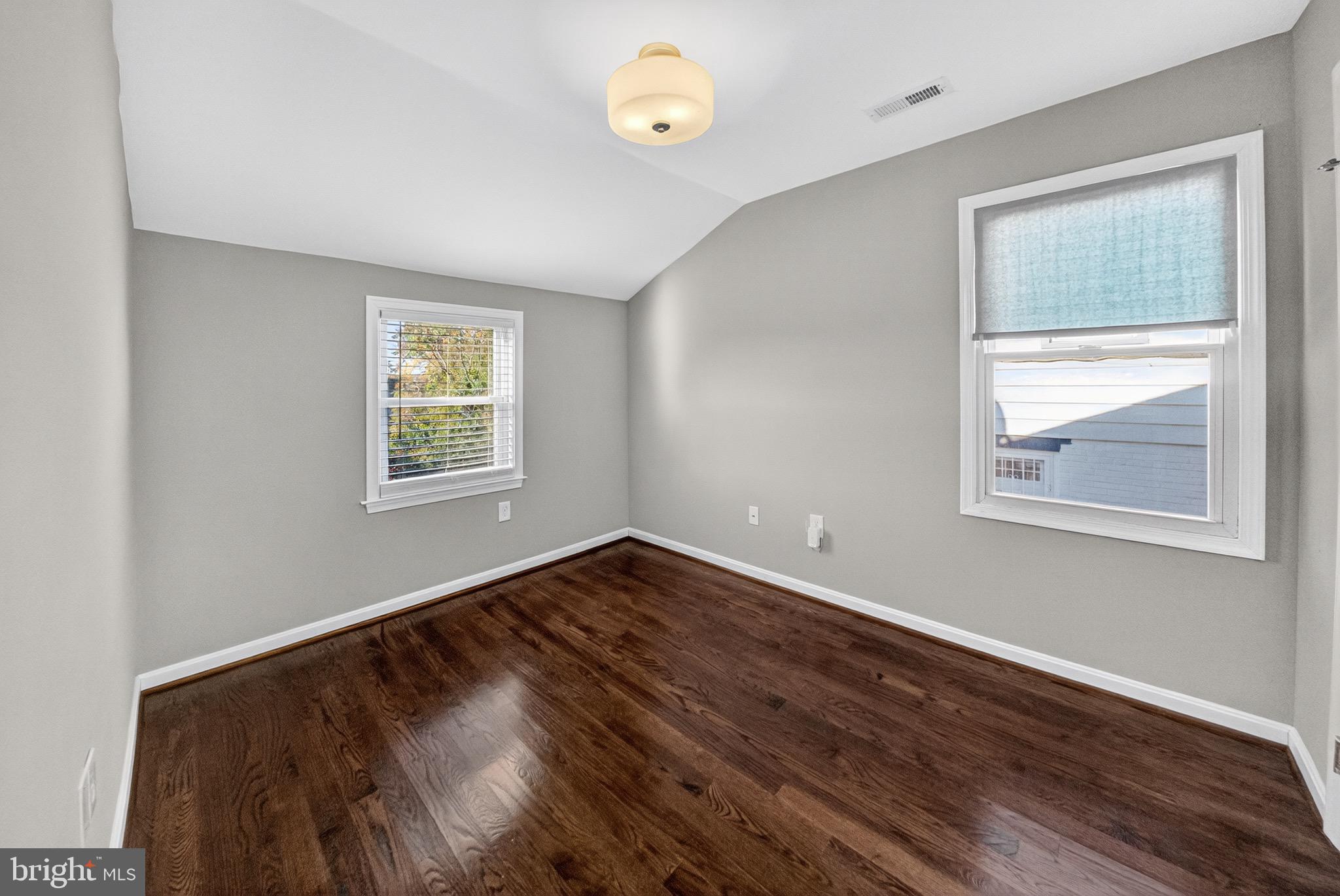 5211 Jay Street Northeast Washington, DC 20019 - Photo 10 of 17 a view of an empty room with wooden floor and a window