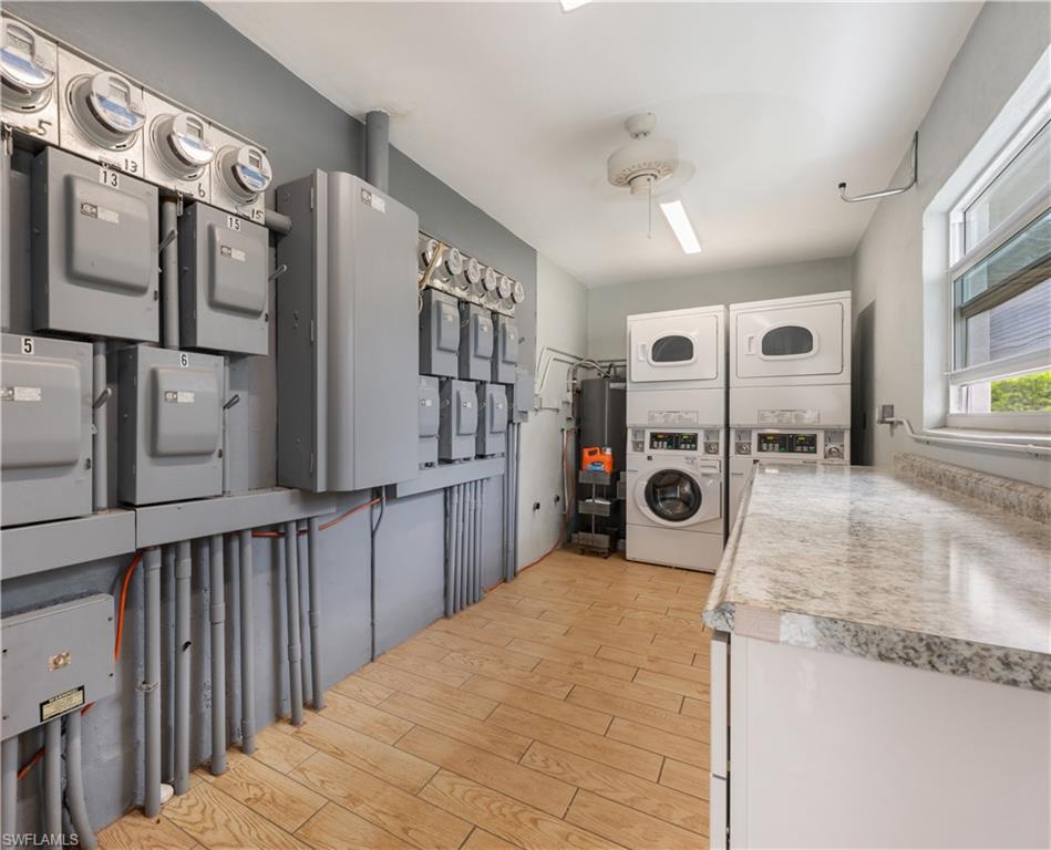 532 4th Avenue South, Unit 2 Naples, FL 34102 - Photo 15 of 19 a kitchen with stainless steel appliances granite countertop a refrigerator a stove and a sink with wooden floor