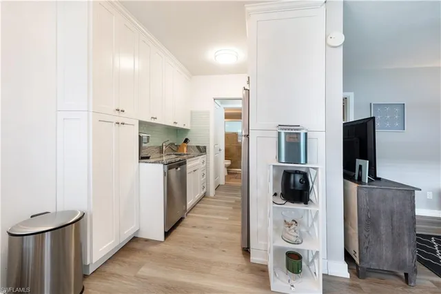 a kitchen with stainless steel appliances a refrigerator and a stove top oven