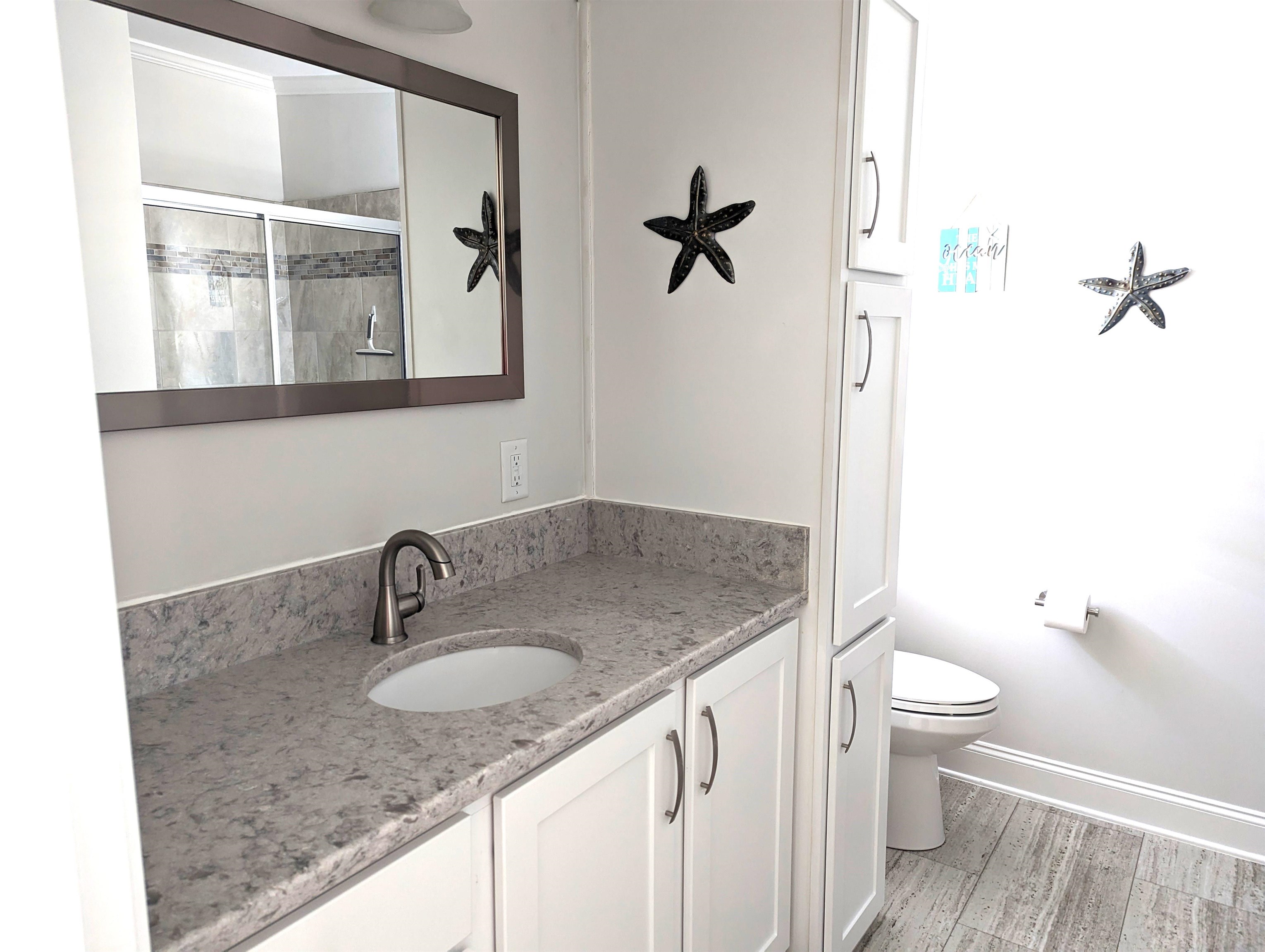 2058 S Shore Ocean View, NJ 08246 - Photo 17 of 27 a bathroom with a granite countertop sink a toilet and a mirror