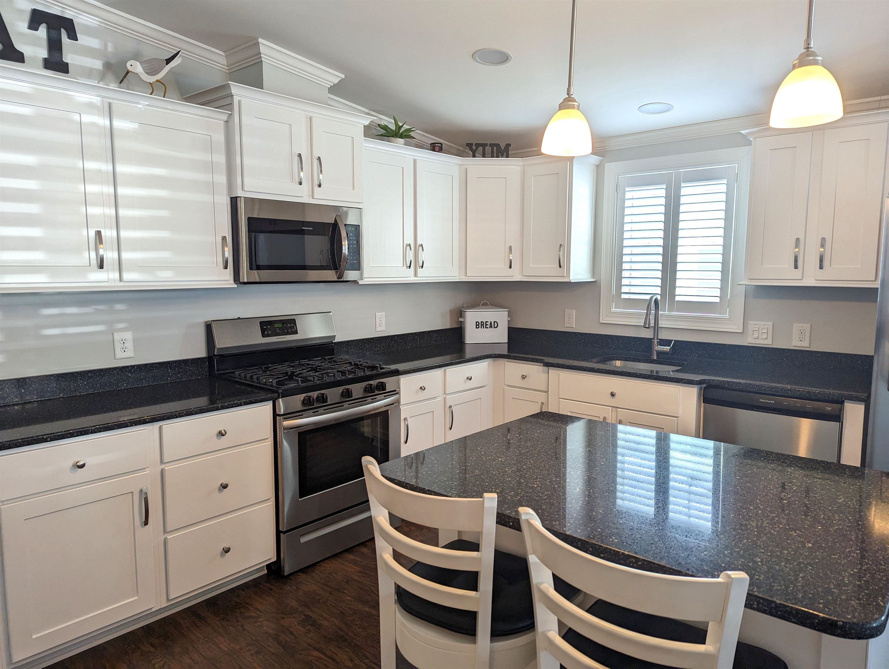 2058 S Shore Ocean View, NJ 08246 - Photo 9 of 27 a kitchen with granite countertop a stove a sink and a microwave