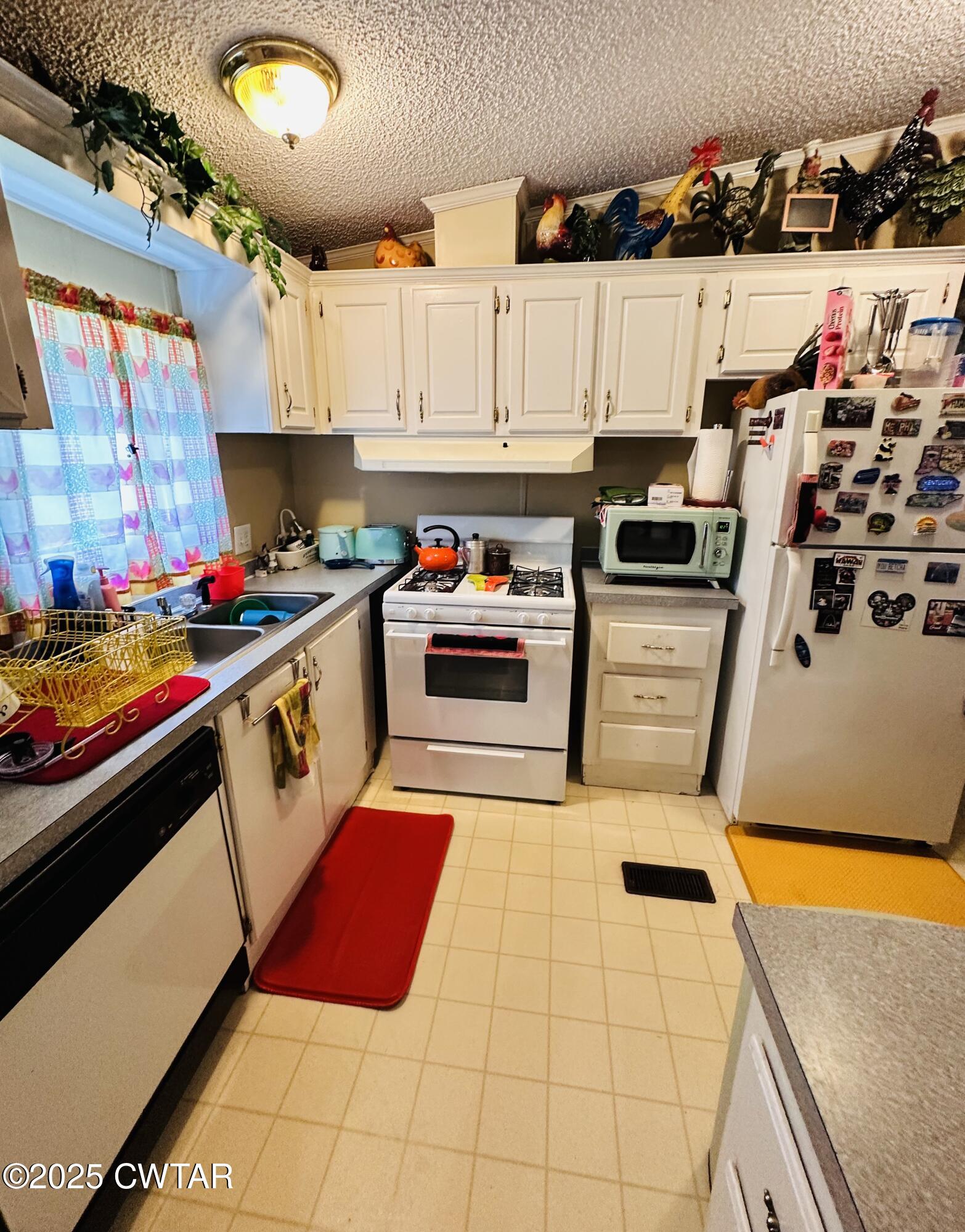 1730 Stallings Road Humboldt, TN 38343 - Photo 7 of 21 a kitchen with stainless steel appliances a stove a sink and a refrigerator
