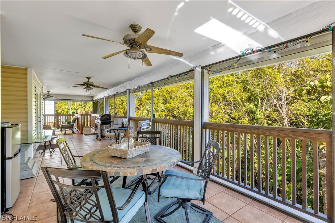 888 Rabbit Road Sanibel, FL 33957 - Photo 23 of 28 a view of a dining room with furniture window and outside view