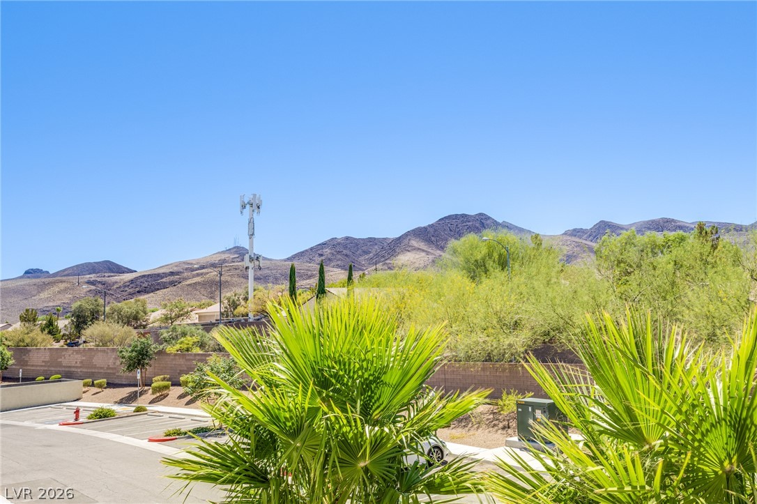 2555 Hampton Road, Unit 8206 Henderson, NV 89052 - Photo 2 of 25 Arid mountains rise majestically behind lush desert foliage, creating a captivating vista.