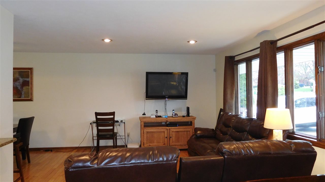 4874 Braewild Road Rockford, IL 61107 - Photo 4 of 23 a living room with furniture and a flat screen tv
