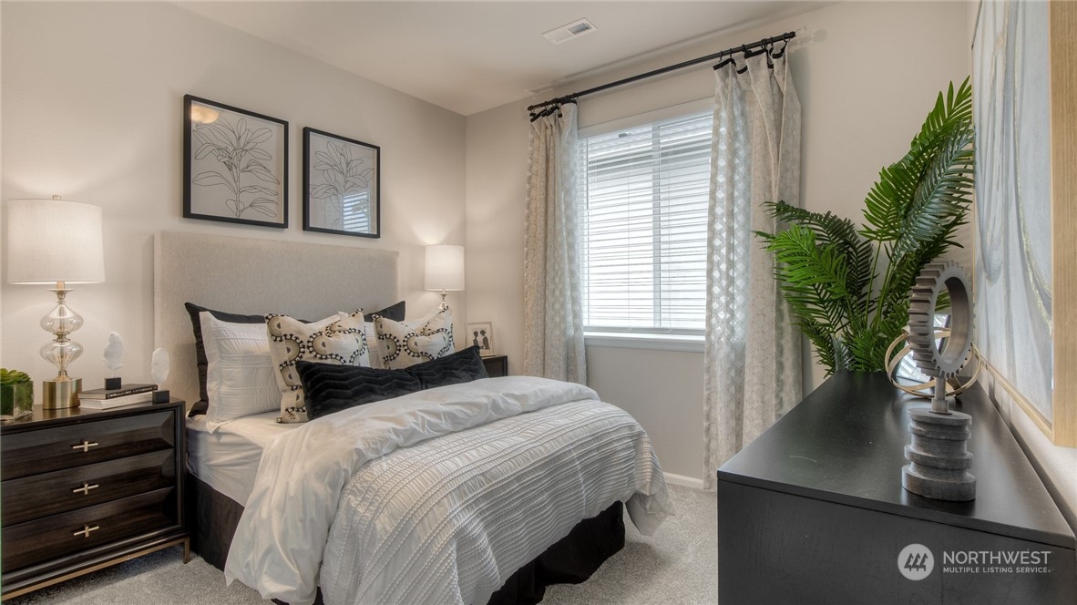 1017 Panoramic Loop, Unit 95 Bremerton, WA 98312 - Photo 13 of 14 a bedroom with a large bed and a potted plant