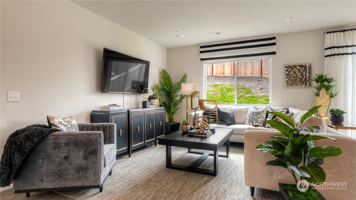 1017 Panoramic Loop, Unit 95 Bremerton, WA 98312 - Photo 4 of 14 a living room with furniture a large window and a flat screen tv