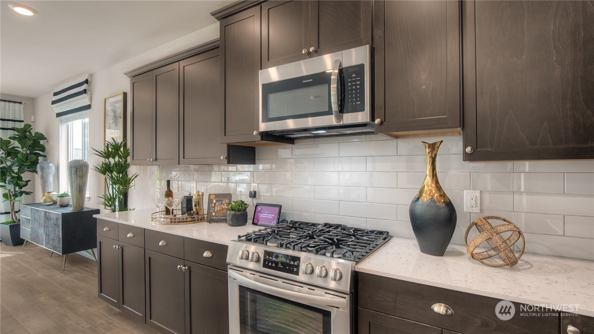1017 Panoramic Loop, Unit 95 Bremerton, WA 98312 - Photo 7 of 14 a kitchen with granite countertop a stove and a microwave