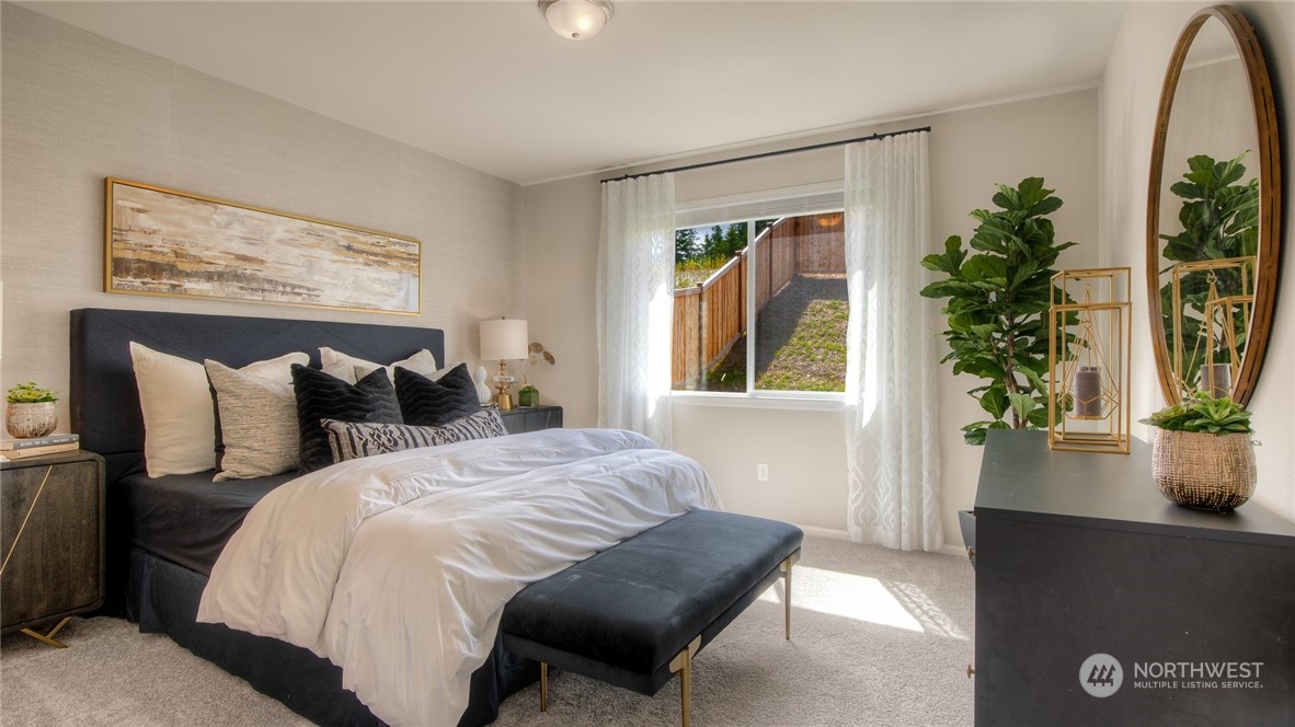 1017 Panoramic Loop, Unit 95 Bremerton, WA 98312 - Photo 9 of 14 a bed sitting in a bedroom next to a window