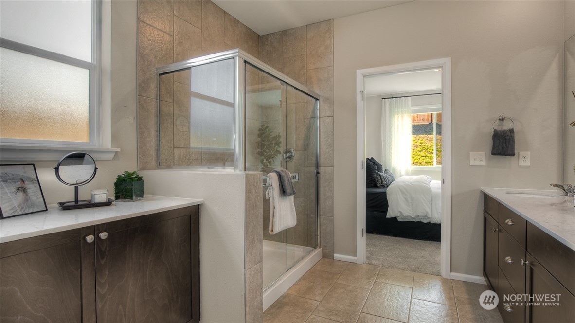 1017 Panoramic Loop, Unit 95 Bremerton, WA 98312 - Photo 10 of 14 a en suite bathroom with a granite countertop sink and a mirror