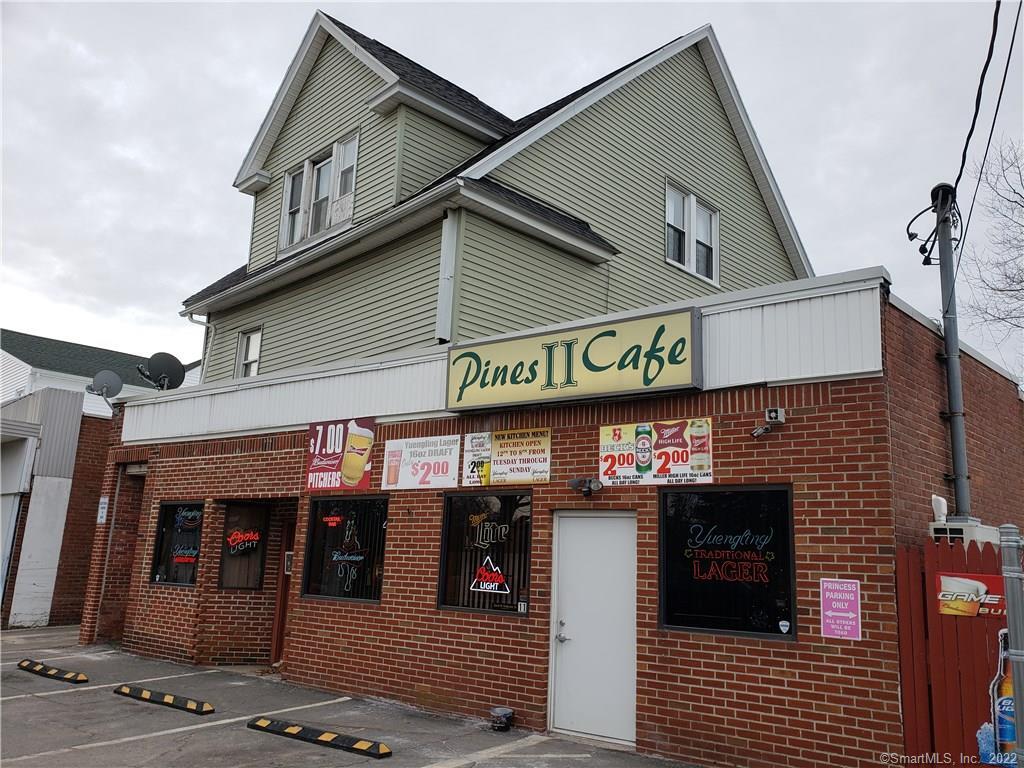 9 Woodtick Road Waterbury, CT 06705 - Photo 1 of 1 a front view of a building with retail shops