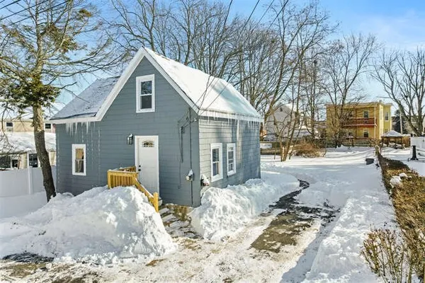 a view of a house with snow in the background