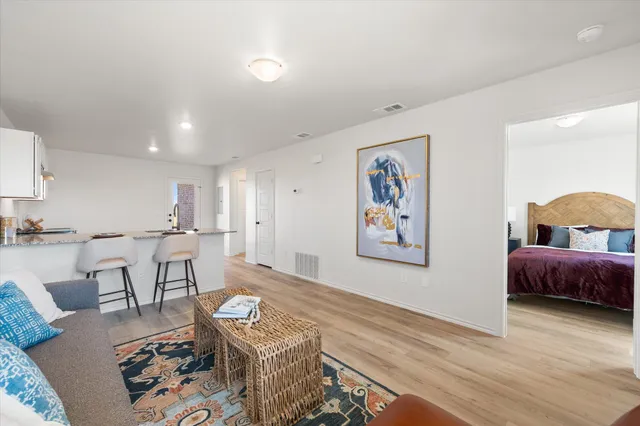 a living room with furniture and wooden floor