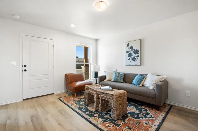 a living room with furniture and wooden floor
