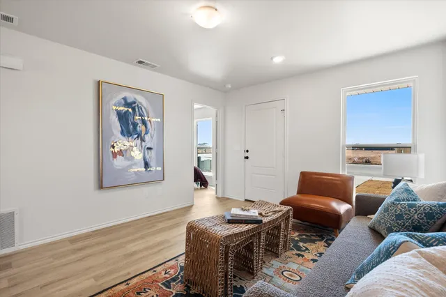 a living room with furniture and wooden floor