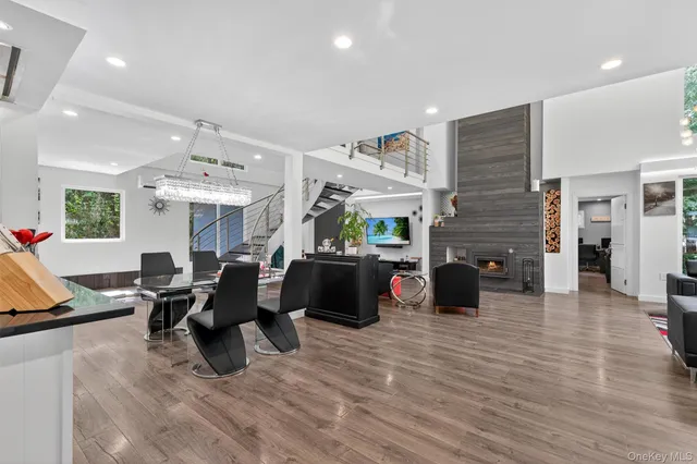 a living room filled with furniture and floor to ceiling windows
