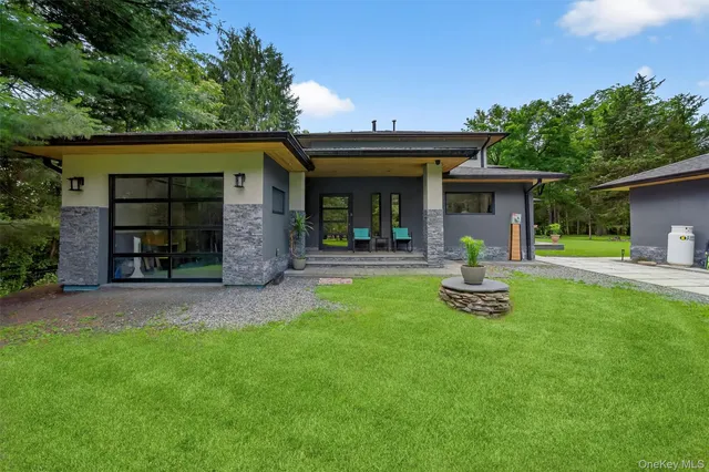 a front view of a house with garden and plants