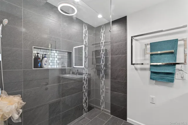 a view of a backyard with table and chairs potted plants and wooden fence