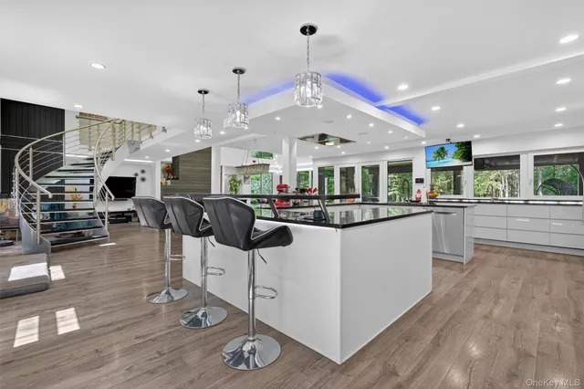 a kitchen with stainless steel appliances a refrigerator sink and microwave