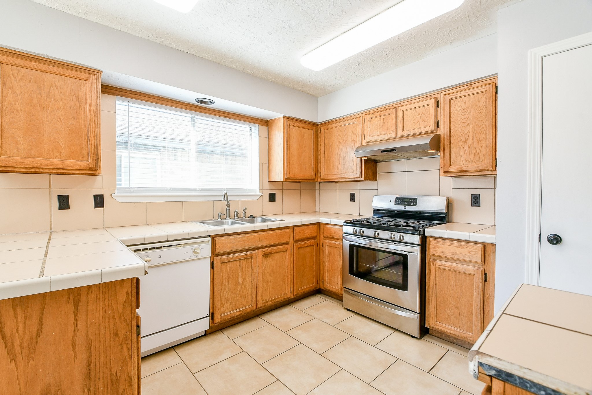 4719 Brownfields Drive Houston, TX 77066 - Photo 12 of 20 a kitchen with granite countertop cabinets stainless steel appliances a sink and a large window