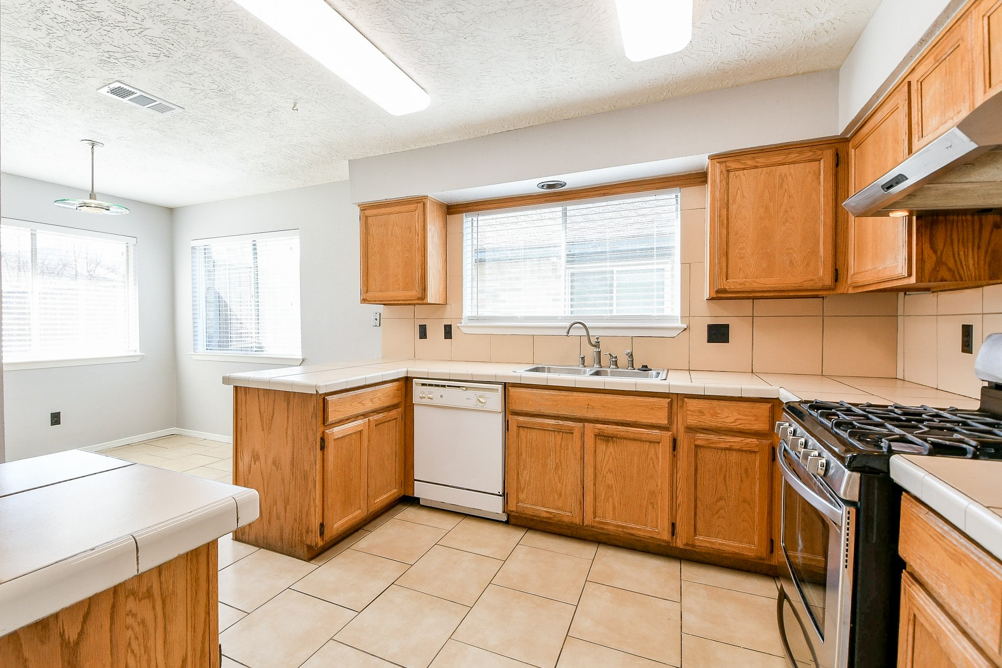 4719 Brownfields Drive Houston, TX 77066 - Photo 13 of 20 a kitchen with stainless steel appliances granite countertop a sink stove and cabinets