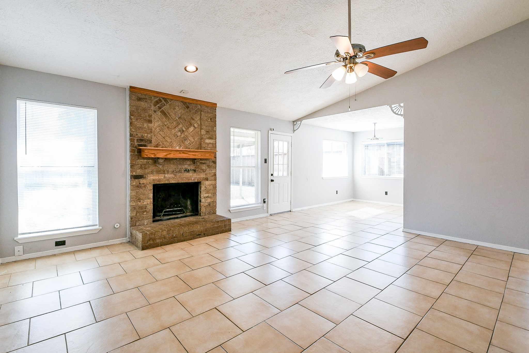4719 Brownfields Drive Houston, TX 77066 - Photo 7 of 20 an empty room with windows and fireplace