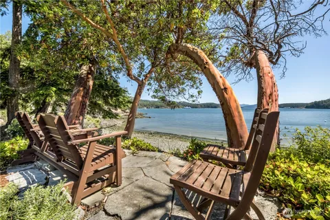 a kitchen with sink a stove and chairs