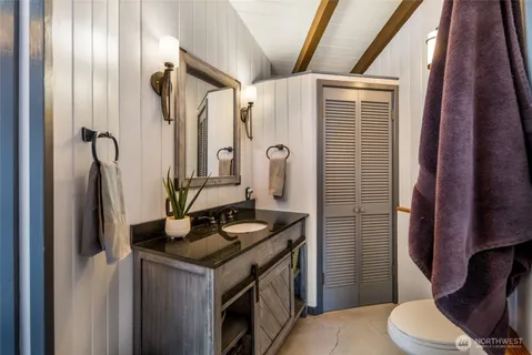 a bedroom with a bed and a view of walk in closet
