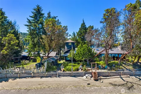 an aerial view of a house with yard and outdoor seating
