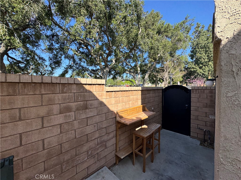 9801 Allesandro Court Rancho Cucamonga, CA 91730 - Photo 19 of 21 a backyard of a house with chairs and wooden fence