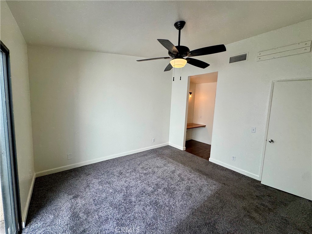 9801 Allesandro Court Rancho Cucamonga, CA 91730 - Photo 8 of 21 an empty room with a window and a fan