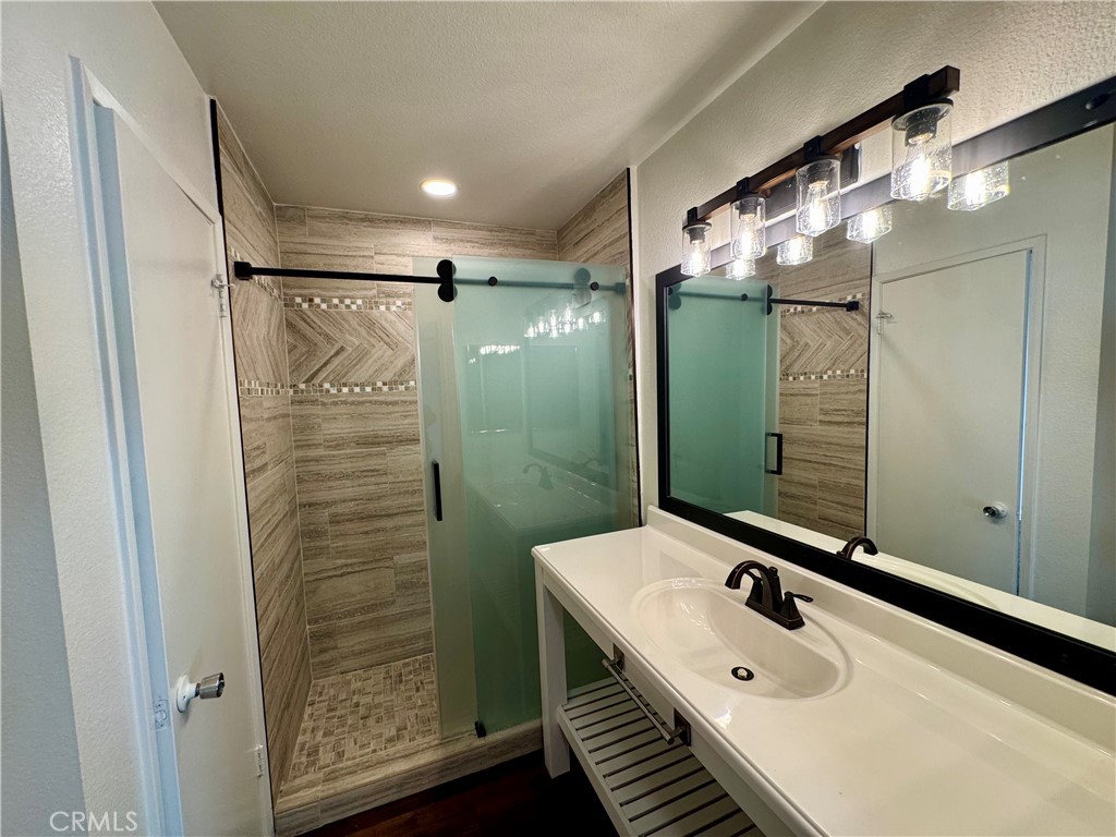 9801 Allesandro Court Rancho Cucamonga, CA 91730 - Photo 10 of 21 a bathroom with a sink mirror and shower