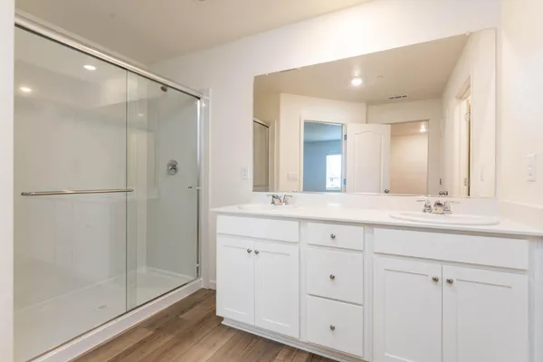 a bathroom with a double vanity sink and mirror