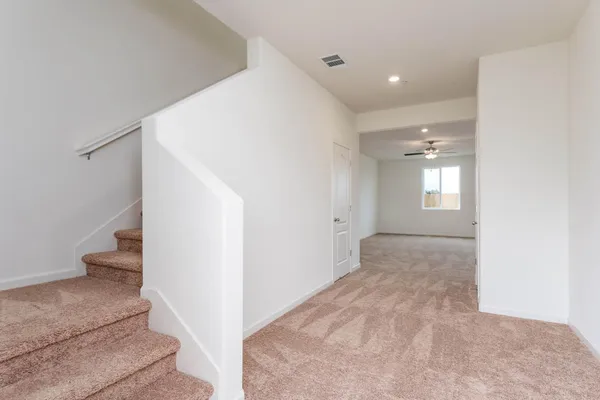 a view of an empty room and stairs