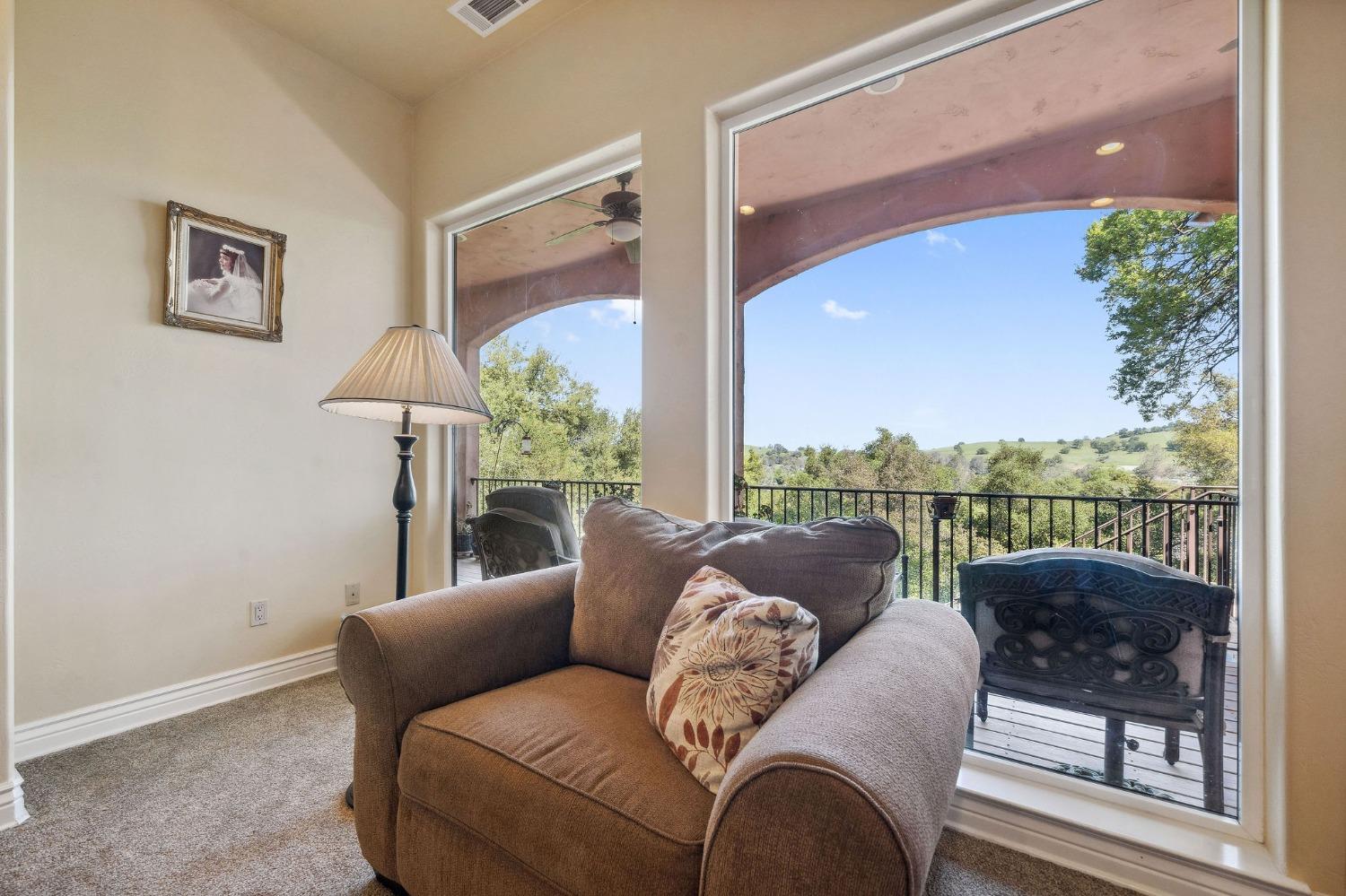 125 Raylan Drive Sutter Creek, CA 95685 - Photo 19 of 79 a living room with furniture and a floor to ceiling window
