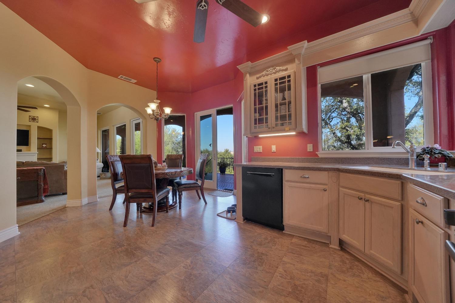 125 Raylan Drive Sutter Creek, CA 95685 - Photo 21 of 79 a kitchen with stainless steel appliances granite countertop dining table chairs and granite counter top