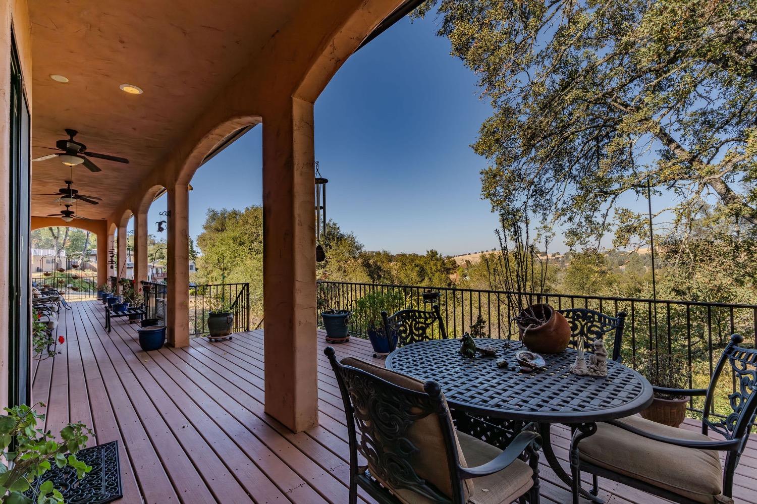 125 Raylan Drive Sutter Creek, CA 95685 - Photo 27 of 79 a view of a balcony with table and chairs and wooden floor