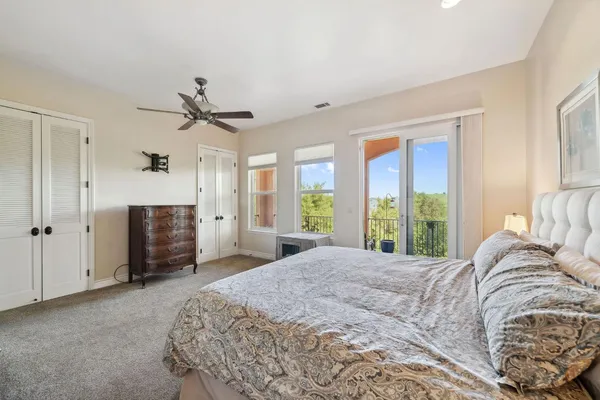 a bedroom with bed and a flat screen tv