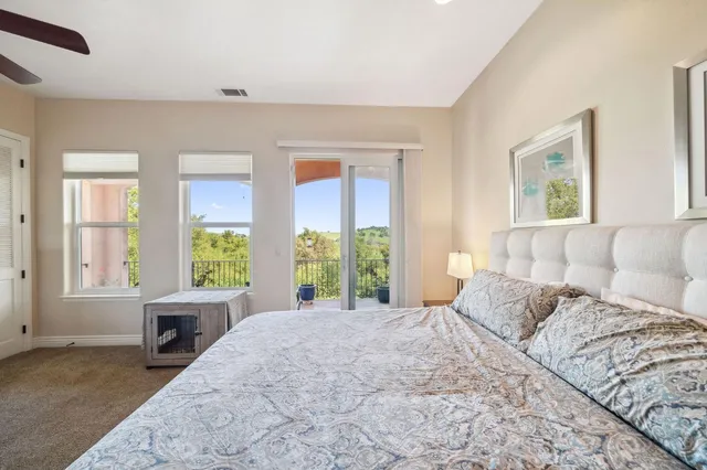 a bedroom with bed and a flat screen tv
