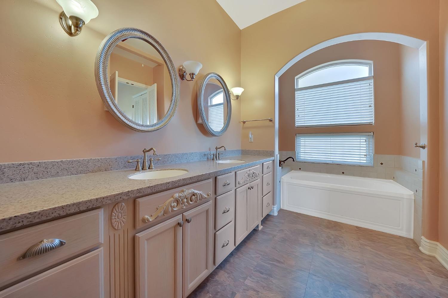 125 Raylan Drive Sutter Creek, CA 95685 - Photo 33 of 79 a bathroom with a double vanity sink and a mirror
