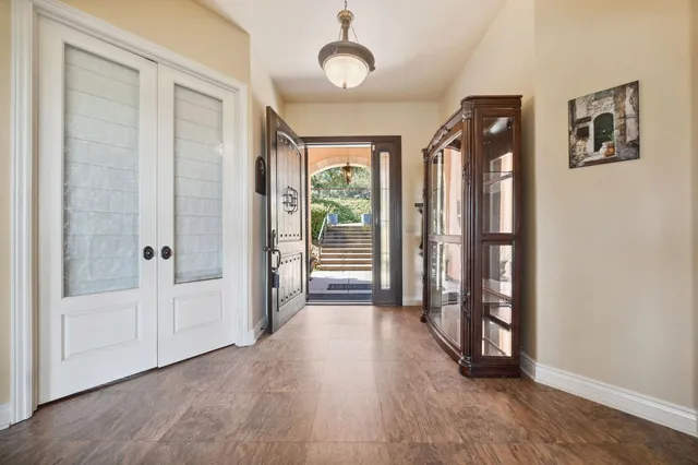 a spacious bedroom with a bed and a chandelier