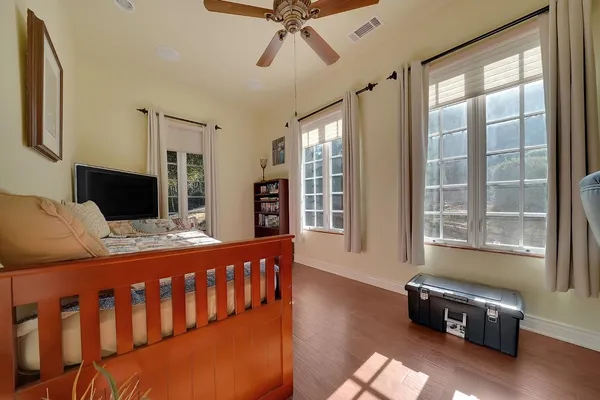 a living room with furniture pool table and wall paintings
