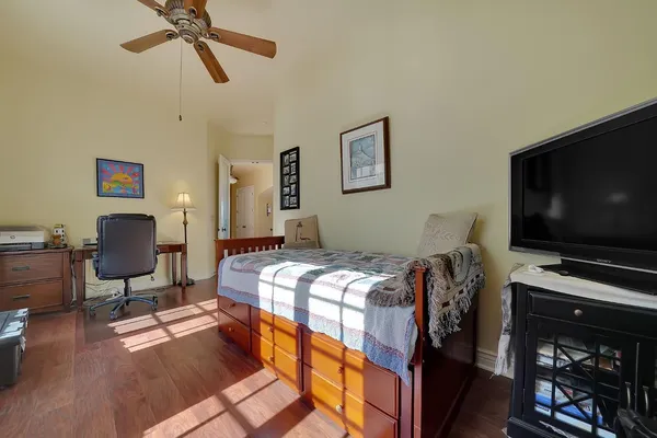 a living room with furniture a flat screen tv and a chandelier