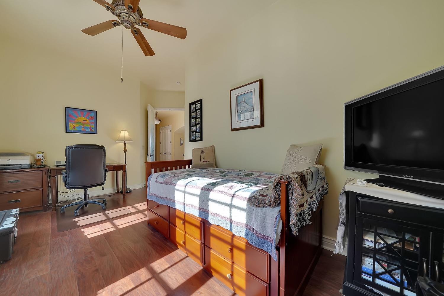 125 Raylan Drive Sutter Creek, CA 95685 - Photo 38 of 79 a bedroom with bed and a flat screen tv