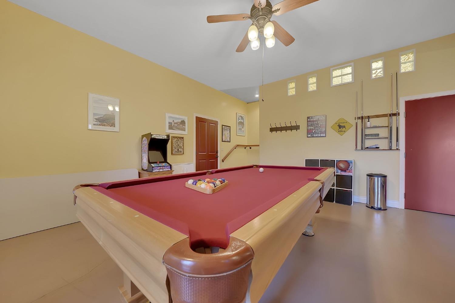 125 Raylan Drive Sutter Creek, CA 95685 - Photo 49 of 79 a spacious bedroom with a bed and a chandelier