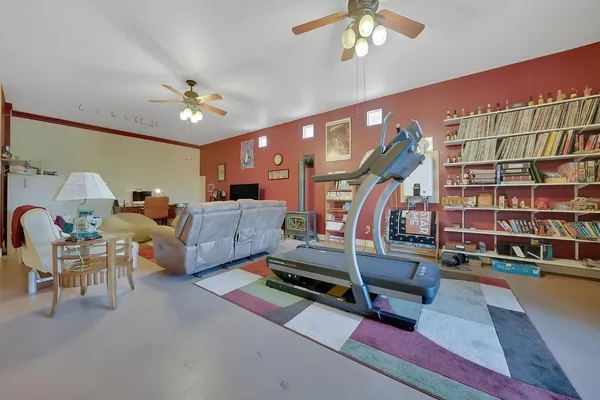 a view of a house with a small yard plants and large tree