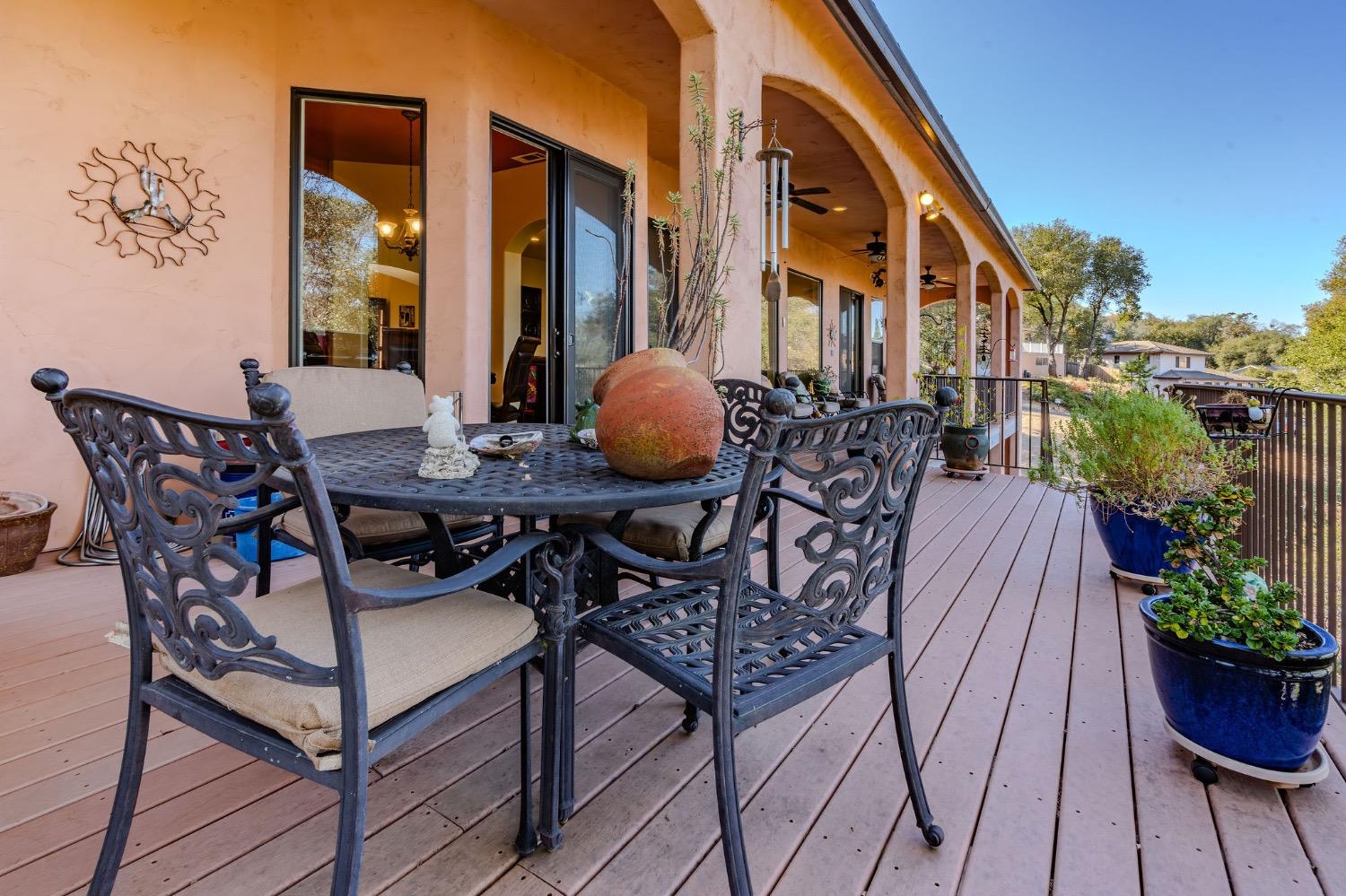 125 Raylan Drive Sutter Creek, CA 95685 - Photo 7 of 79 a view of a patio with table and chairs potted plants with wooden floor