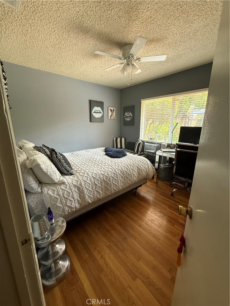 4535 Ramsdell Avenue La Crescenta, CA 91214 - Photo 15 of 28 a bedroom with a bed and wooden floor